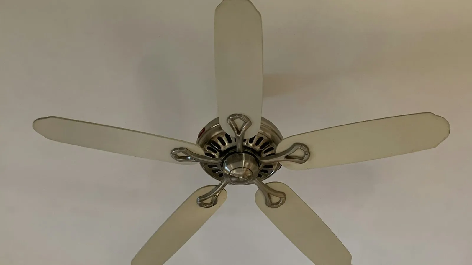 A five-blade ceiling fan seen from below