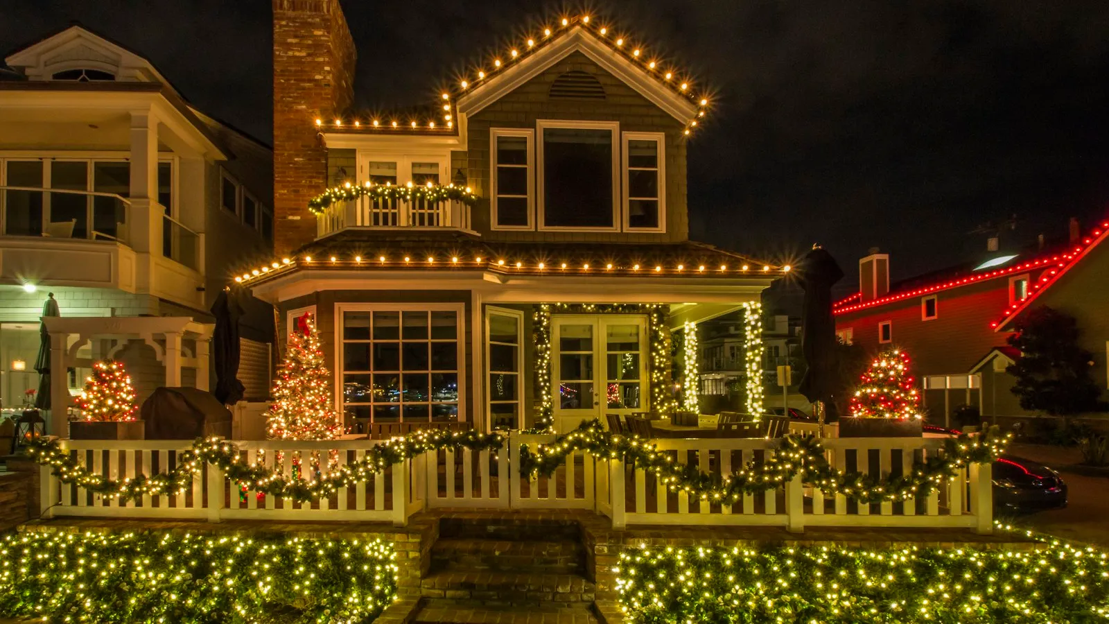 A house at night covered in warm white Christmas lights