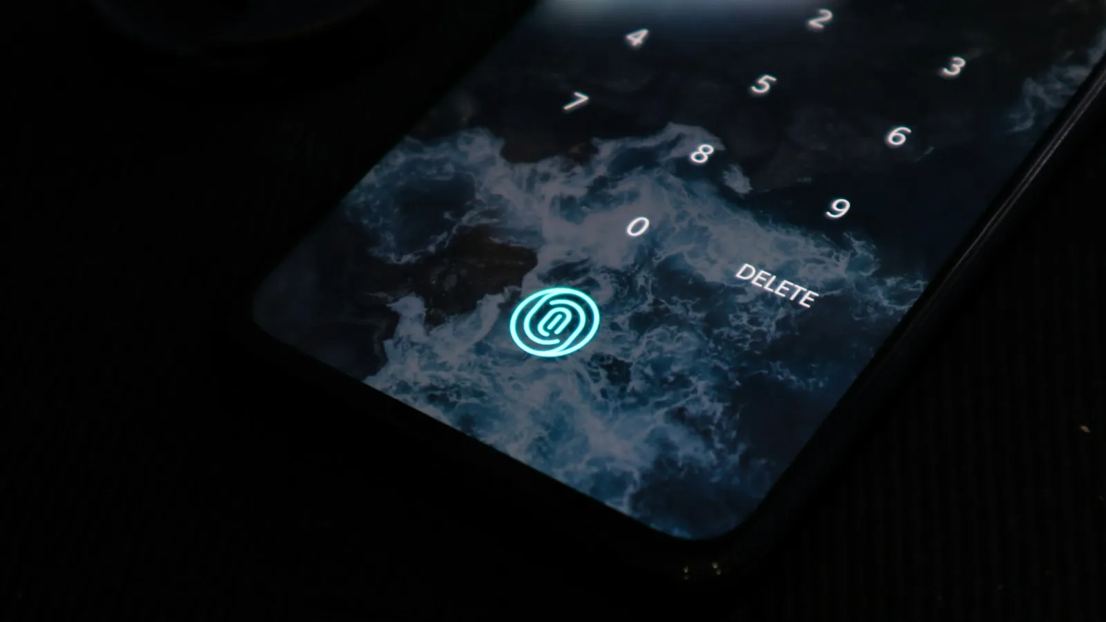 Phone lock screen showing a glowing fingerprint icon and number keypad