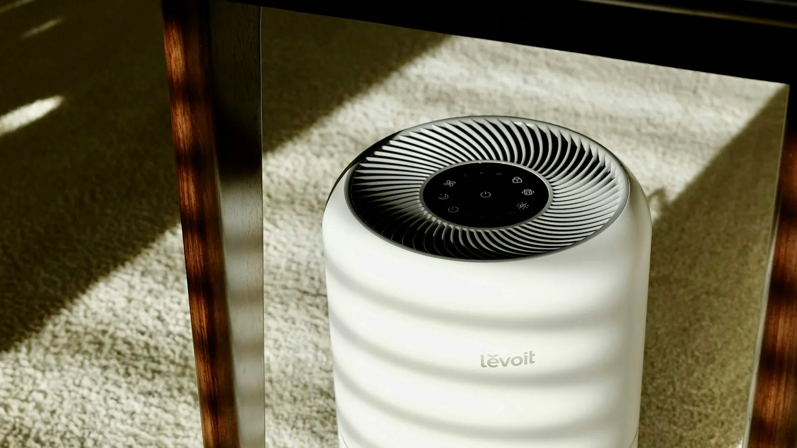 White air purifier on a carpeted floor