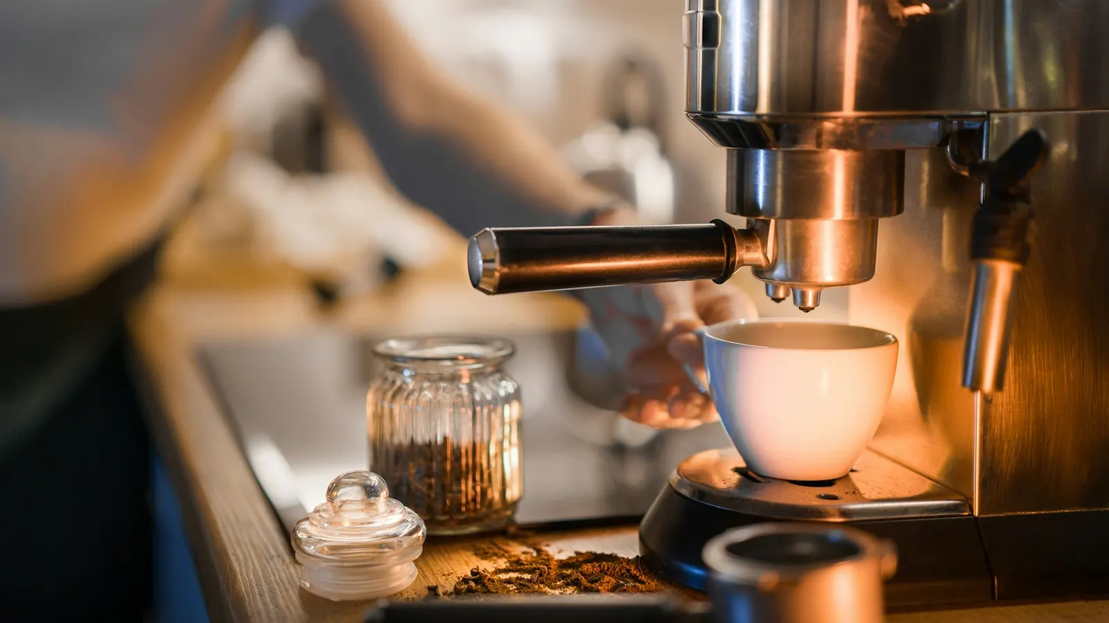A coffee machine filling a white cup on a kitchen counter