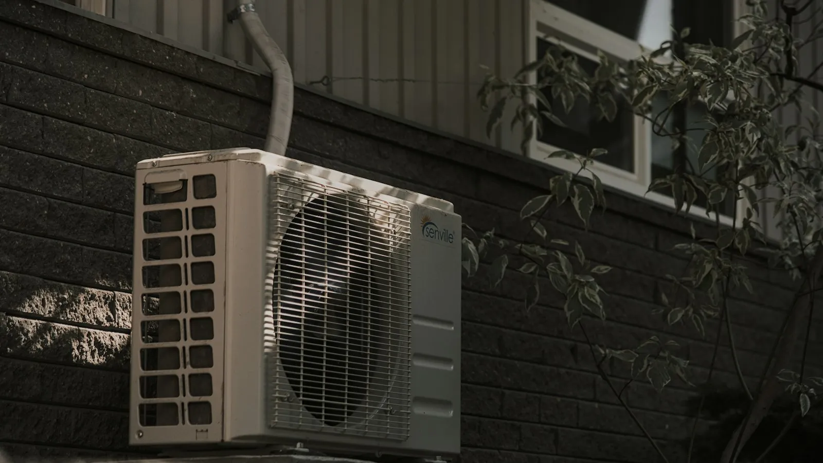 Air conditioner unit mounted on an exterior wall
